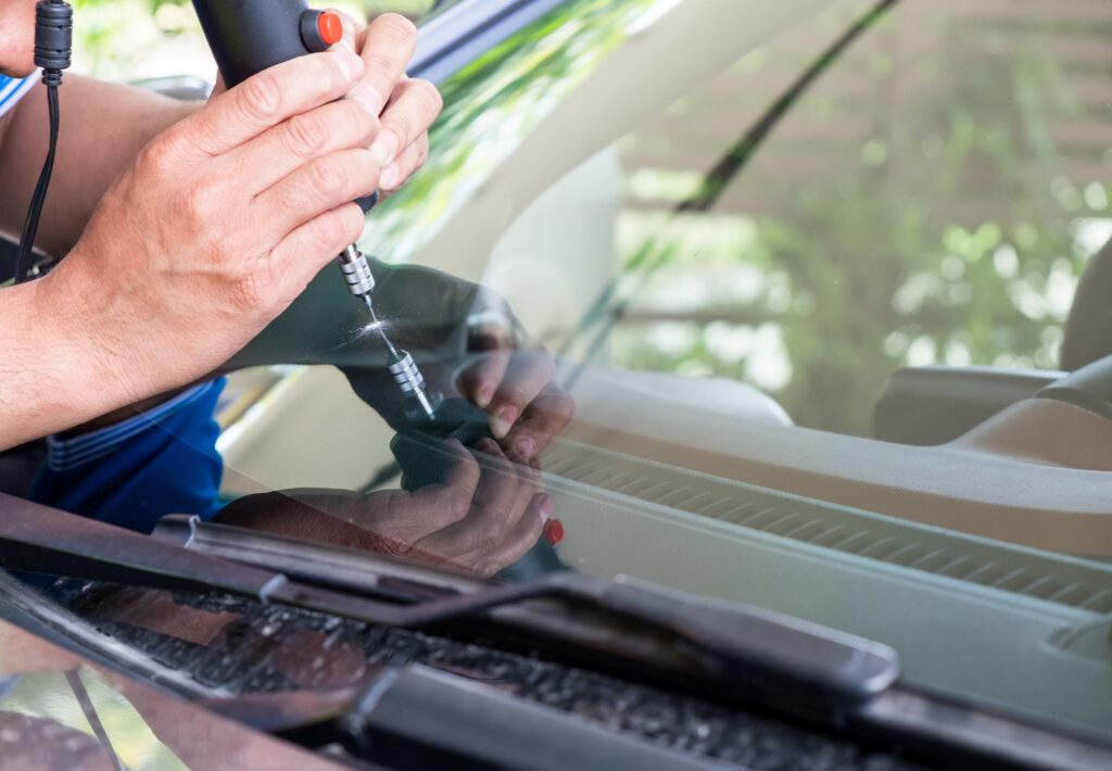 glazier using tools repairing to fix crack 2026 03 24 23 12 26 utc Windshield Repair